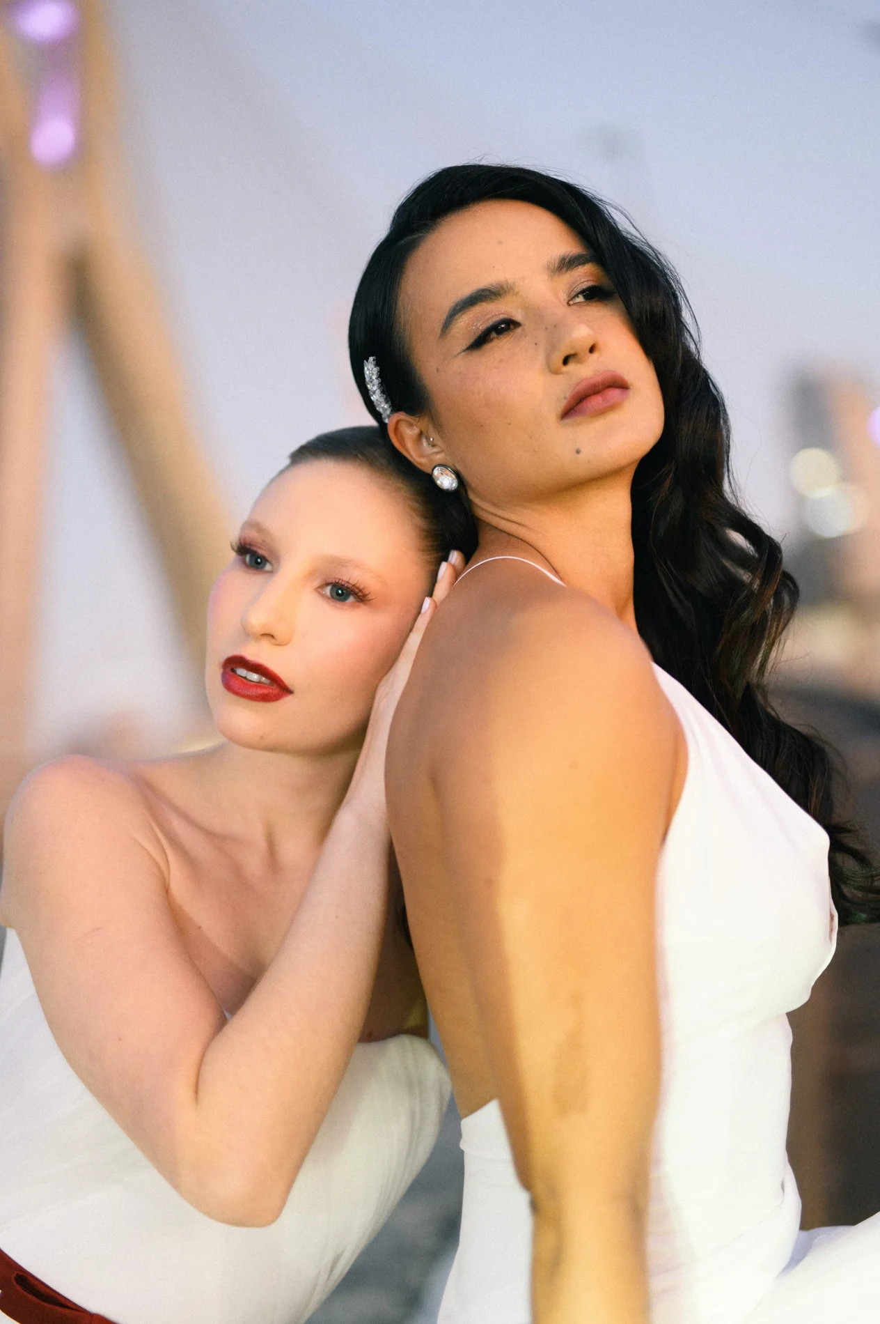 Two models with distinct makeup and hair looks.