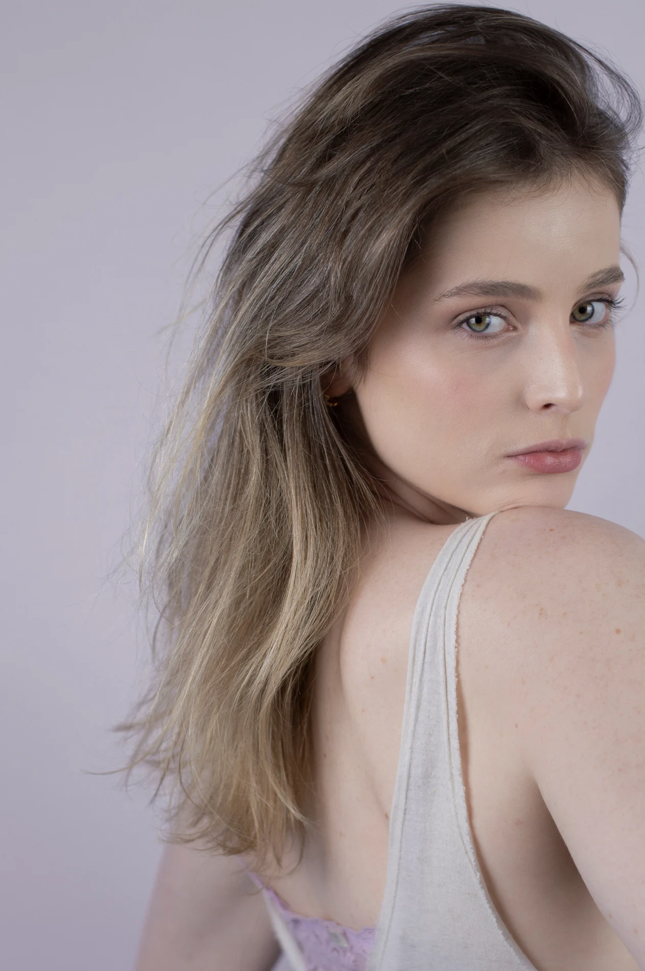 Profile portrait with loose hair and natural texture.