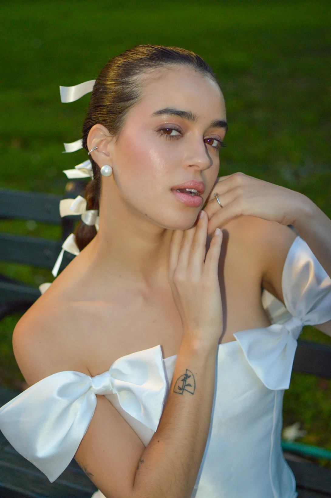 Outdoor beauty portrait with an updo and small pale accessories.